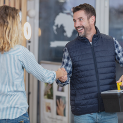 Man shaking a woman's hand.